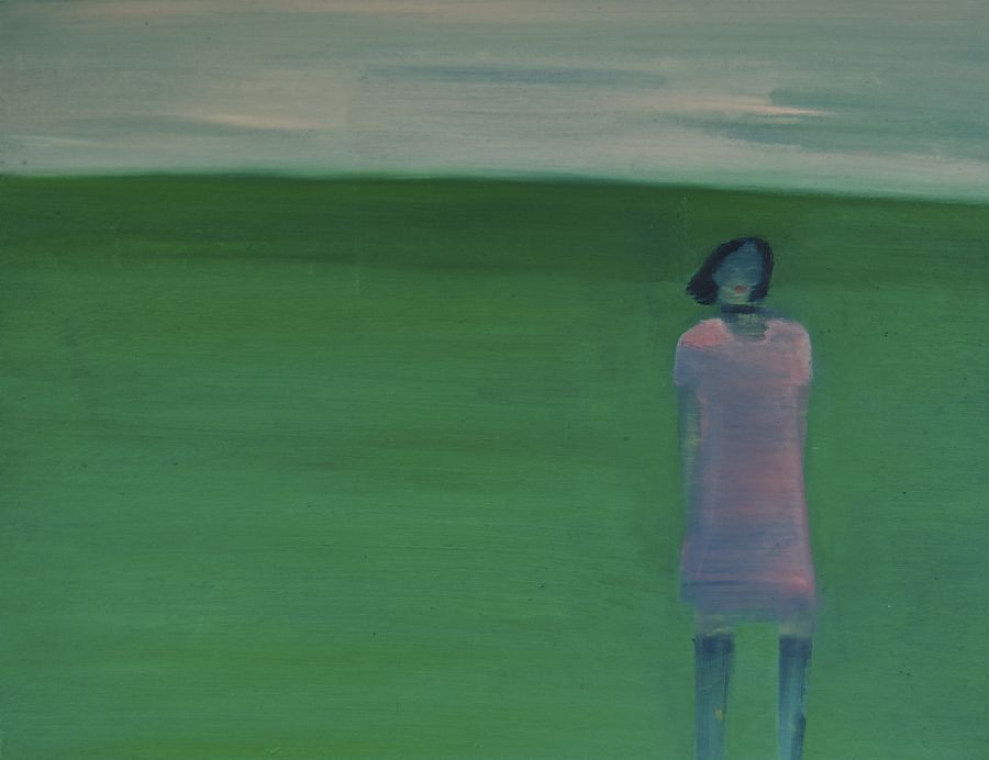 A figure standing on a green lawn.