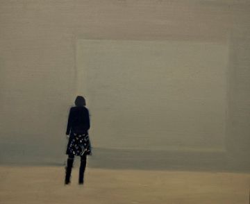 Silhouette of a woman from behind staring at a painting on the wall inside a gallery.