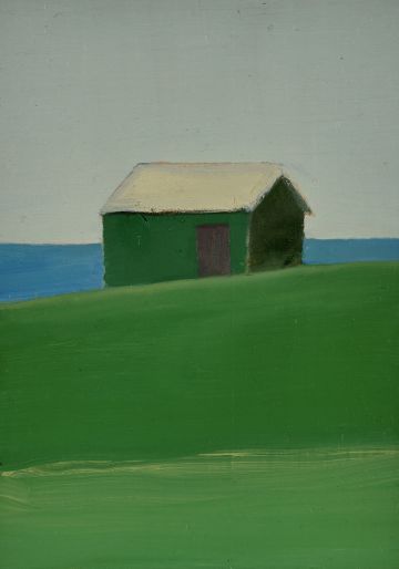A green shack on a green hill on the seashore.