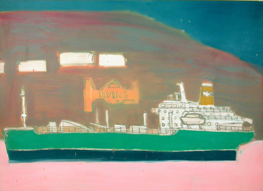 An oil cargo ship in a pink sea with land and buildings behind.