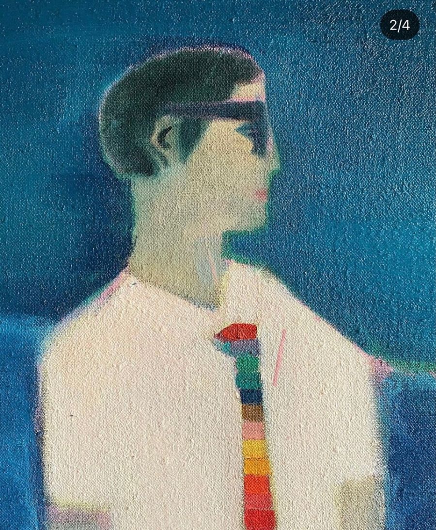 Portrait of a man wearing glasses and a multicoloured tie.